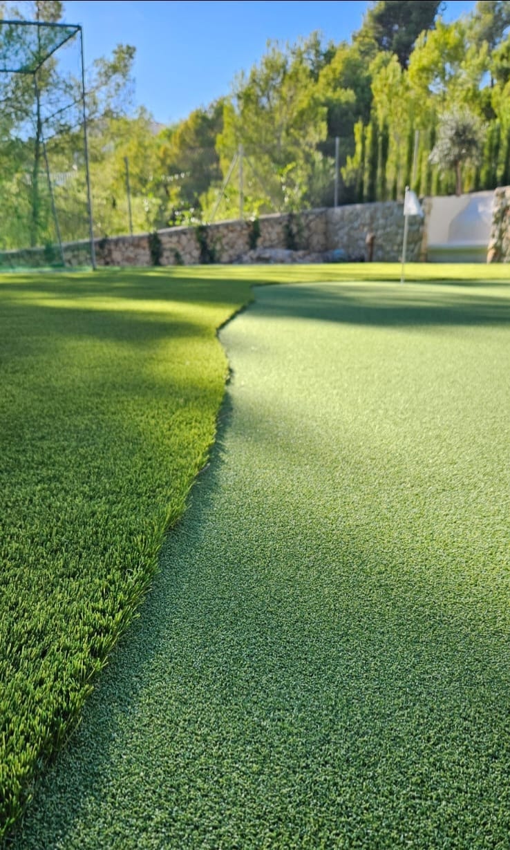 Close-up putting green surface with flag artificial grass Spain